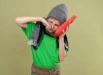 ill-little-boy-wearing-green-t-shirt-warm-scarf-hat-feeling-unwell-holding