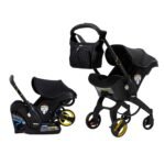 "Doona Car Seat & Stroller Midnight Edition all-in-one travel system in stroller mode with black canopy and wheels"